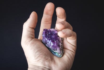 And amethyst specimen in the palm of a hand