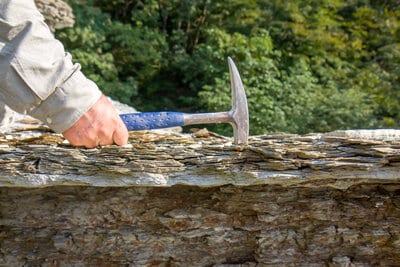 A rock hammer being used