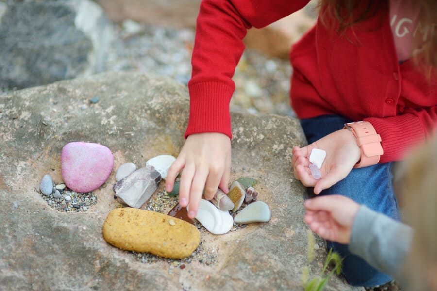Children gathered around a collection of rocks
