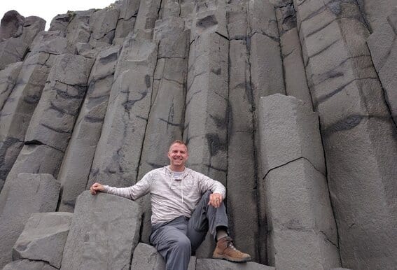 Me sitting in front of a wall of columnar basalt