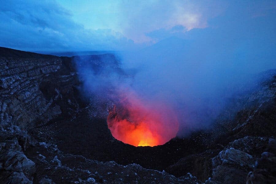 The glowing lava lake and ash plumes of Masaya as the sun sets.