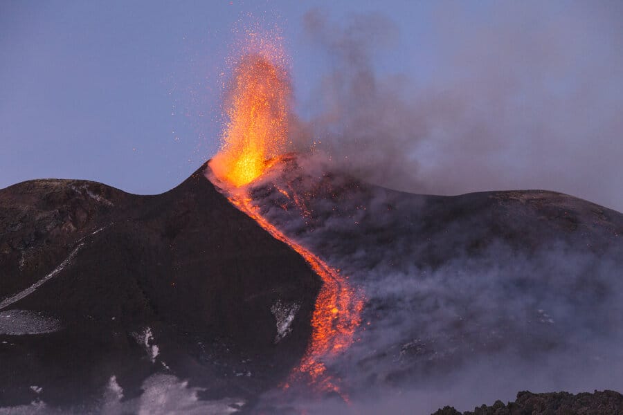 A spectacular strombolian eruption of Mount Etna at dusk.