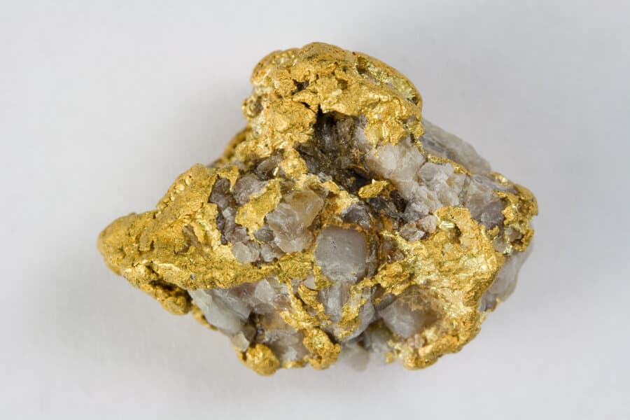 A specimen of native gold in quartz showing the yellow color and habit of gold.
