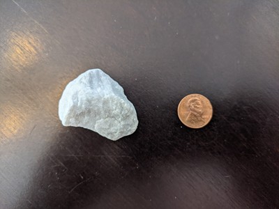 A landscaping rock with penny for scale. Rock is about 3 times the size of the penny